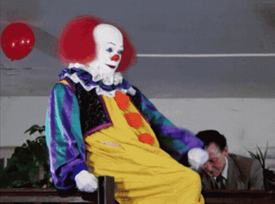 Clown Sitting On Bench With Red Balloon GIF