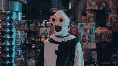 Clown Standing In Front Of Sunglasses Display GIF
