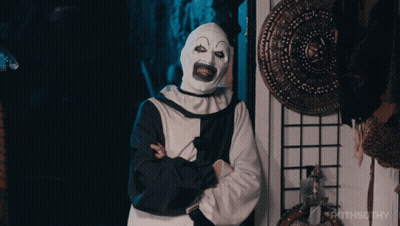 Clown With Arms Crossed In Front Of Rothsothy Sign GIF