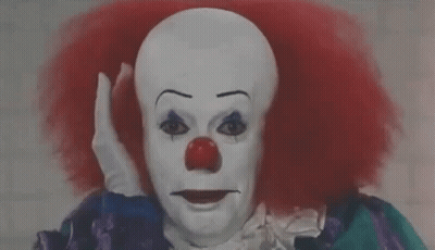 Clown With Red Hair And Red Nose Making Funny Face GIF