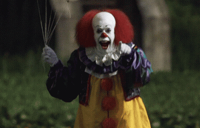 Clown With Red Hair Holding Balloon GIF