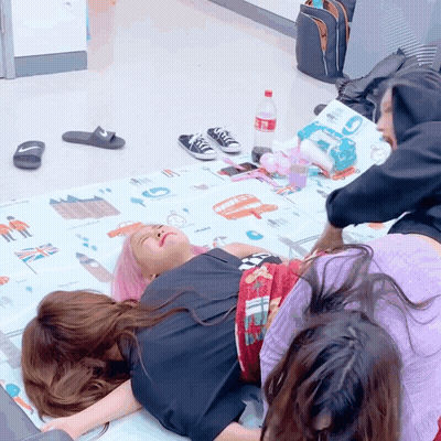 Coca Cola Bottle Next To Woman Laying On Mat GIF