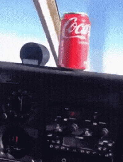 Coca Cola Can On Plane Dashboard GIF