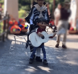 Coco Miguel Playing Guitar While Marching GIF