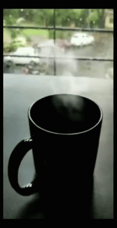 Coffee Cup On Table In Front Of Window GIF