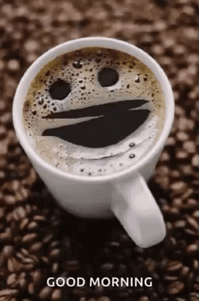 Coffee Cup With Smiley Face Foam On Coffee Beans GIF