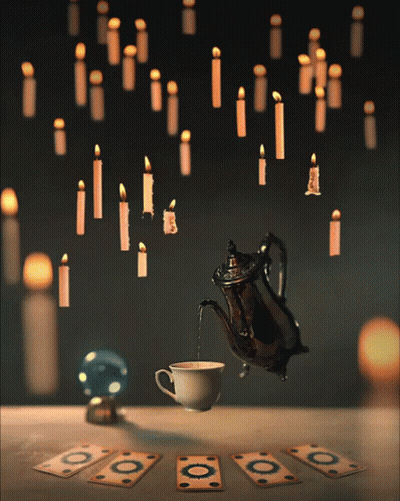Coffee Poured Into Teapot With Hanging Candles GIF