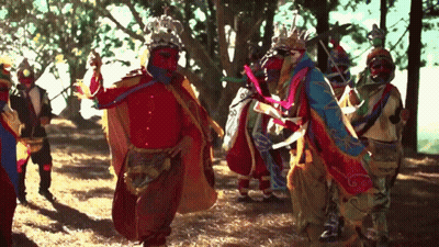 Colorful Costumes Dancing In Forest GIF