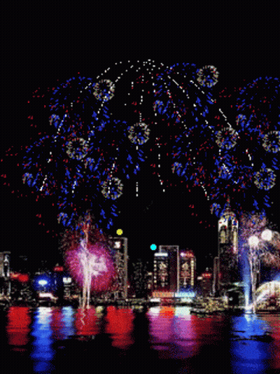 Colorful Fireworks Over City GIF