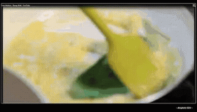 Computer Screen Showing Yellow Spoon Stirring Substance GIF
