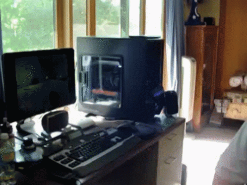 Computer Sitting On Desk Next To Keyboard GIF