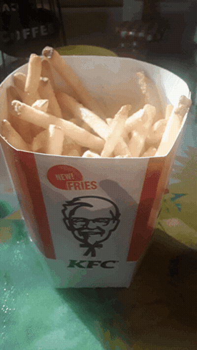 Container Of KFC French Fries On Green Table GIF