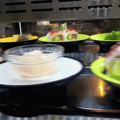 Conveyor Belt With Plates Of Food And Bowl Of Soup GIF