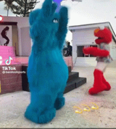 Cookie Monster And Elmo Dancing On Stage GIF