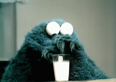 Cookie Monster Drinking A Glass Of Milk With Eggs In His Eyes GIF