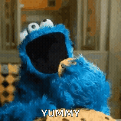Cookie Monster Eating Cookie Saying Yummy GIF