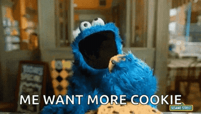 Cookie Monster From Sesame Street Is Eating A Cookie And Says Me Want More Cookie GIF
