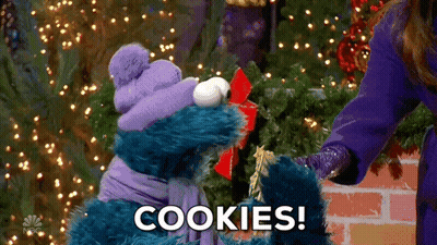 Cookie Monster From Sesame Street Is Giving A Gift To A Woman GIF