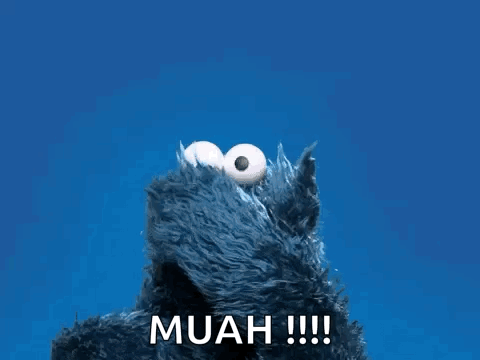 Cookie Monster From Sesame Street Says Muah !!! In Front Of A Blue Background GIF