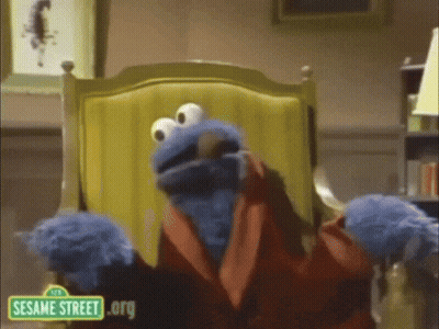 Cookie Monster Is Sitting In A Chair With A Sesame Street .Org Logo GIF