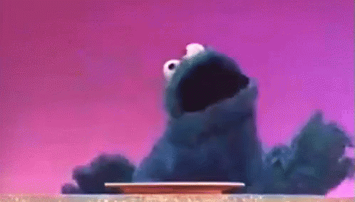 Cookie Monster Standing Next To Plate With Mouth Open GIF