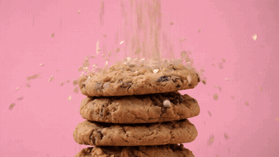 Cookie With Bite Taken Out On Pink Background GIF