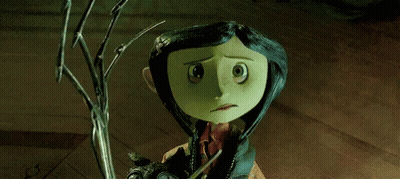 coraline from coraline the animated movie is holding a cat