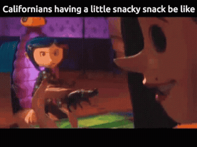 Coraline From Coraline The Animated Movie Is Holding A Cat In Her Hand GIF