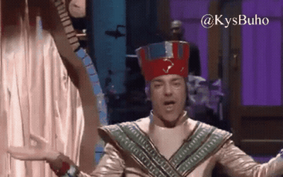 Costumed Man With Red Hat And Purple Wall GIF