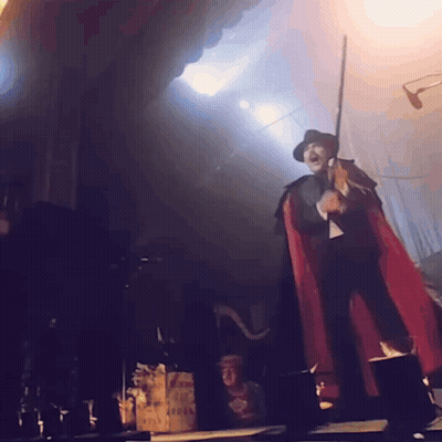 Costumed Person With Eye On Head On Stage GIF