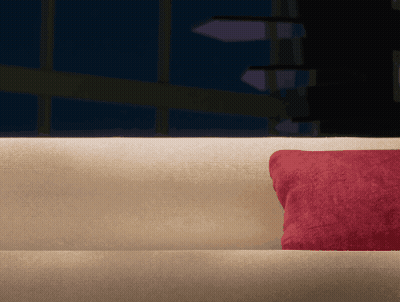 Couch With Red Pillow In Dark Room GIF