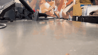 Counter With Scanner And People Picture On Wall GIF