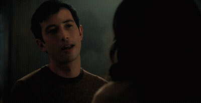 Couple Eye To Eye With Red Curtain GIF
