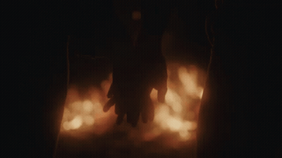 Couple Holding Hands In Front Of Fire GIF