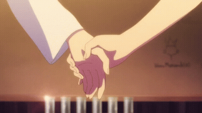 Couple Holding Hands in Front of Piano With Candles
