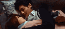 Couple In Bed Sweetly Kissing GIF