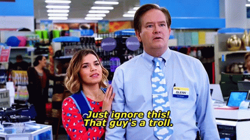 Couple In Store With Tie Saying Just Ignore This GIF