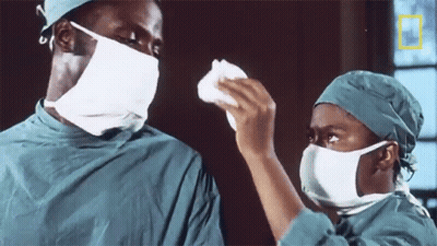 Couple In Surgical Masks With National Geographic Logo GIF