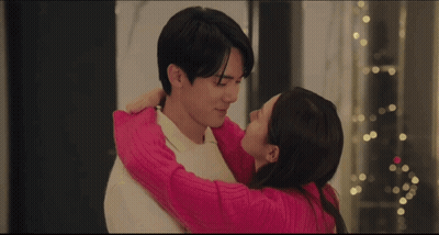 Couple Kissing In Front Of Christmas Tree GIF