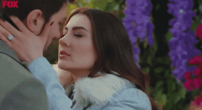 Couple Kissing In Front Of Flowers With Fox GIF