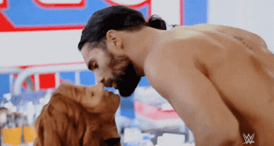 Couple Kissing In Front Of W Sign GIF