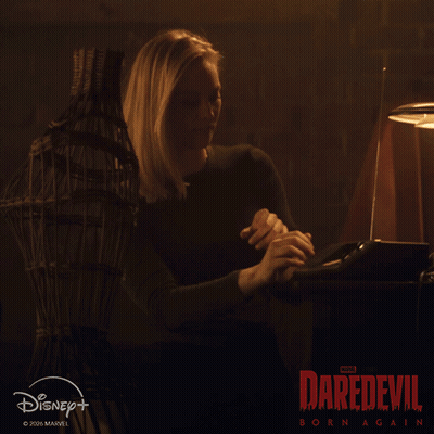 Couple Looking At Each Other In Dark Room GIF