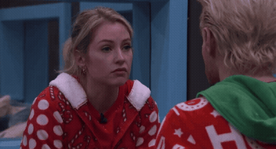 Couple Looking Woman In Red Candy Cane Sweater GIF