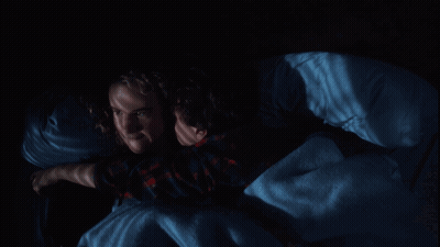 Couple Lying in Bed Saying Get Off Me in Red