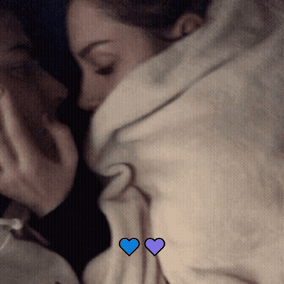 Couple Lying Under Blanket With Blue Hearts GIF