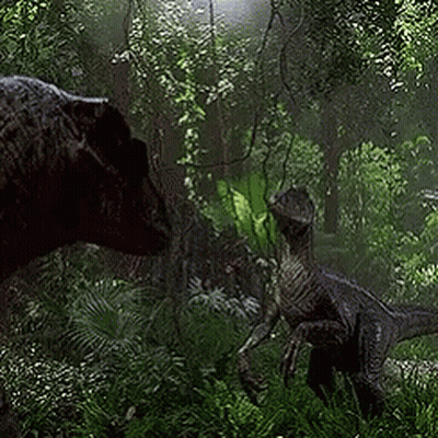 Couple Of Dinosaurs Standing In Lush Green Forest GIF