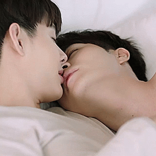 Couple Of Men Kissing While Laying In Bed GIF