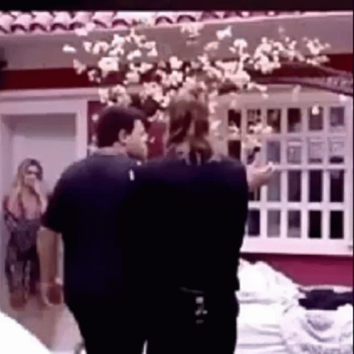 Couple Of People Standing Next To Each Other In Front Of Window GIF