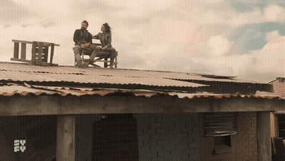 Couple On Roof With SV FV Logo Behind GIF