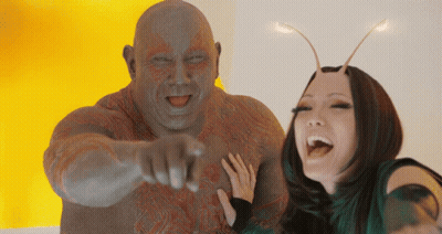 Couple Posing And Man Pointing At Camera GIF